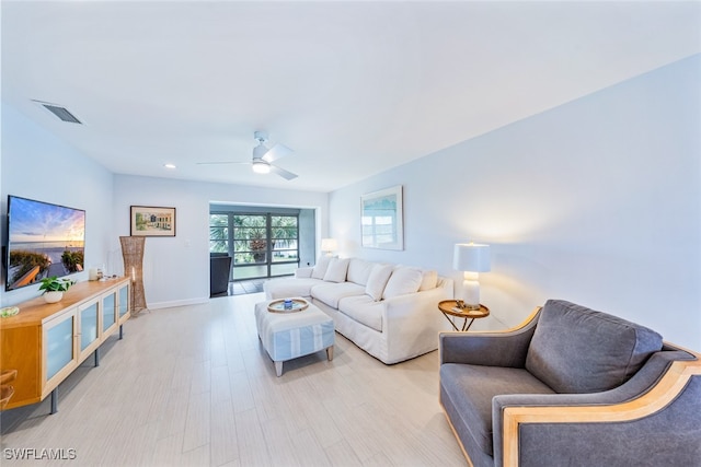 living room featuring ceiling fan and light wood-type flooring