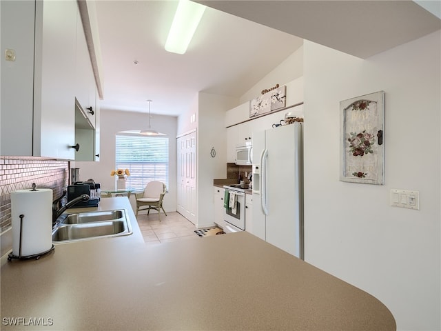 kitchen featuring pendant lighting, white cabinetry, white appliances, sink, and vaulted ceiling