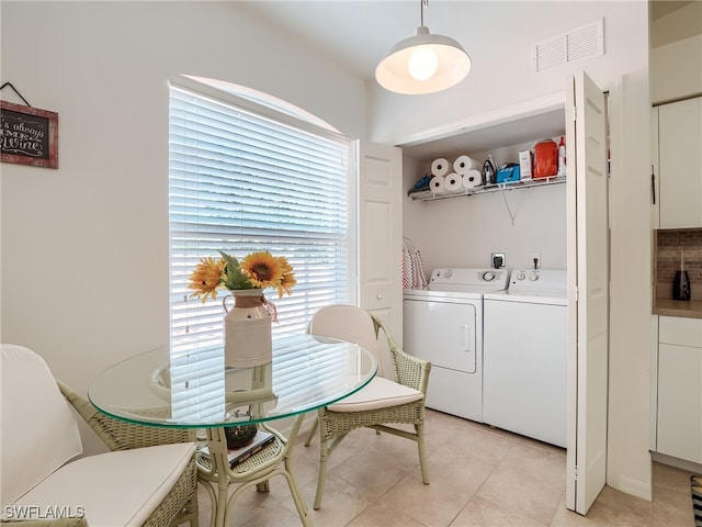 dining room featuring independent washer and dryer and light tile patterned floors