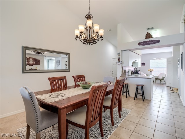 dining space with high vaulted ceiling, light tile patterned floors, and a notable chandelier