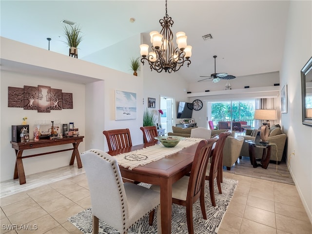 dining room featuring ceiling fan with notable chandelier, high vaulted ceiling, and light tile patterned floors