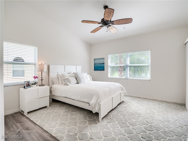 bedroom with lofted ceiling, ceiling fan, and light wood-type flooring