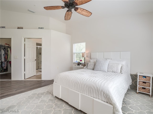 bedroom featuring a closet, ceiling fan, a spacious closet, and light hardwood / wood-style flooring