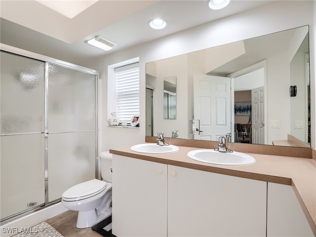 bathroom featuring vanity, toilet, and walk in shower