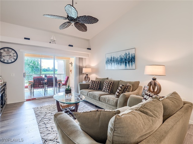 living room with high vaulted ceiling, hardwood / wood-style floors, and ceiling fan