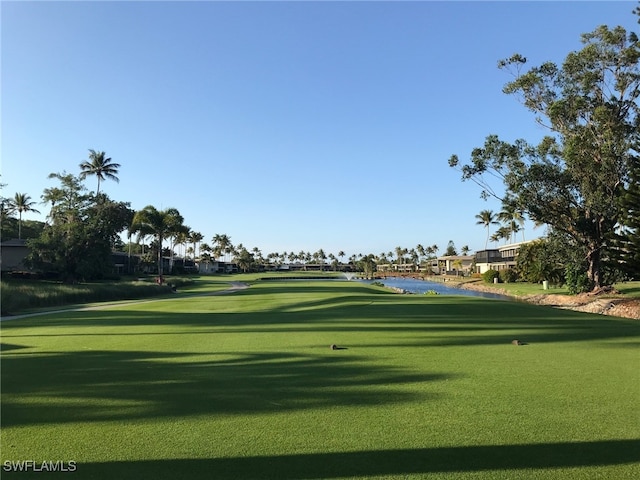 view of home's community featuring a yard and a water view