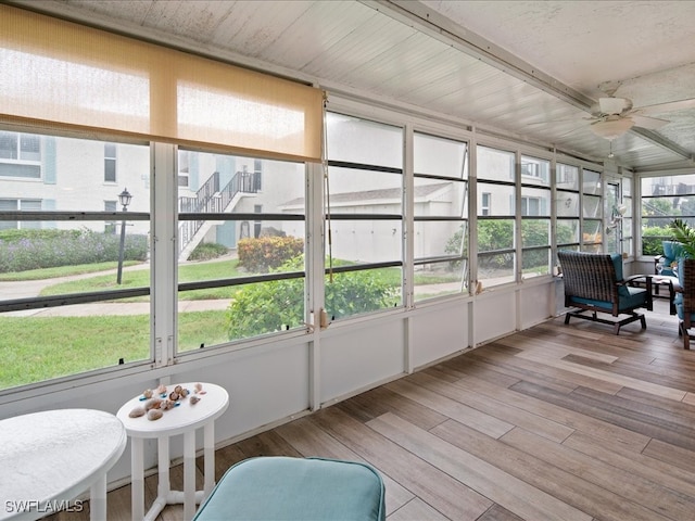 sunroom / solarium featuring ceiling fan and a wealth of natural light