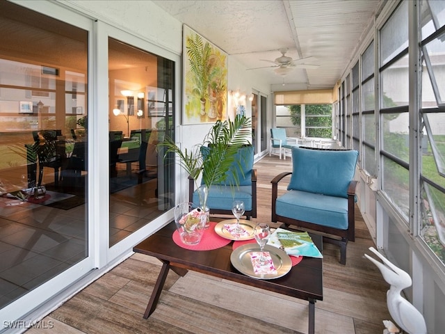 sunroom / solarium featuring ceiling fan