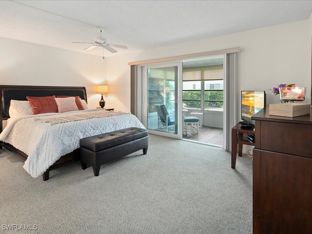 carpeted bedroom featuring a textured ceiling, access to exterior, and ceiling fan