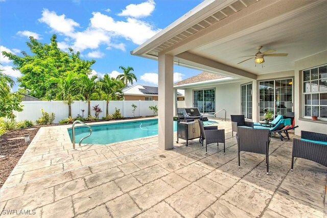 view of swimming pool with ceiling fan and a patio area