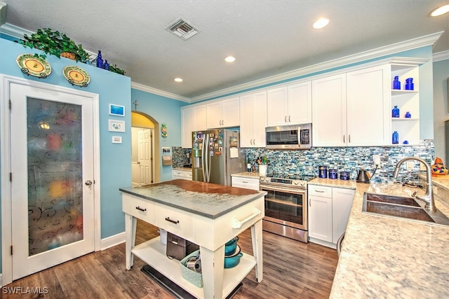 kitchen with crown molding, dark hardwood / wood-style floors, sink, and appliances with stainless steel finishes