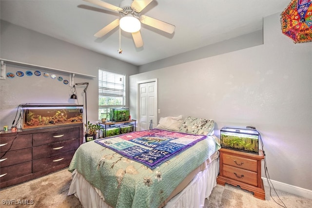 bedroom featuring a closet, ceiling fan, and light carpet