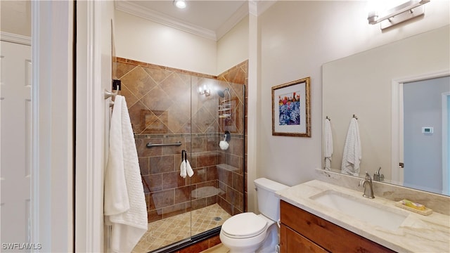 bathroom with ornamental molding, vanity, toilet, and a shower with door