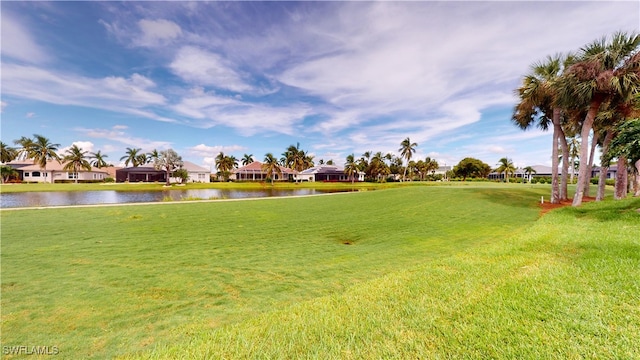 view of community with a lawn and a water view