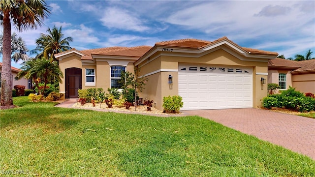 view of front of house with a front yard and a garage