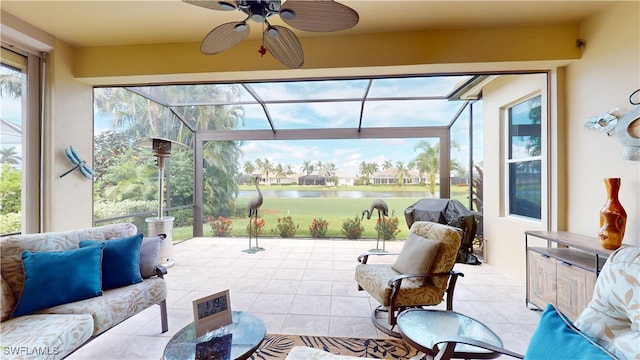 sunroom / solarium with a water view and ceiling fan