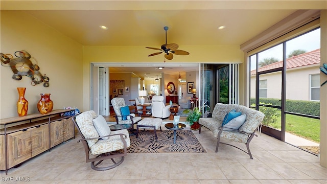 sunroom / solarium featuring ceiling fan