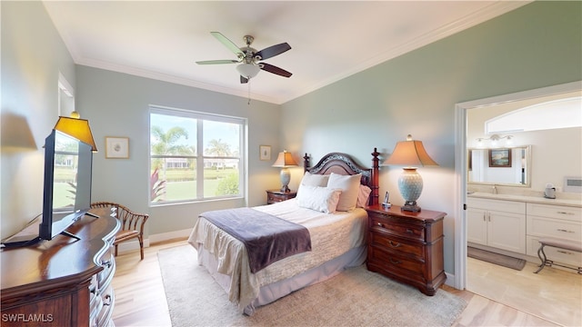 bedroom featuring ornamental molding, light wood-type flooring, ceiling fan, and ensuite bathroom