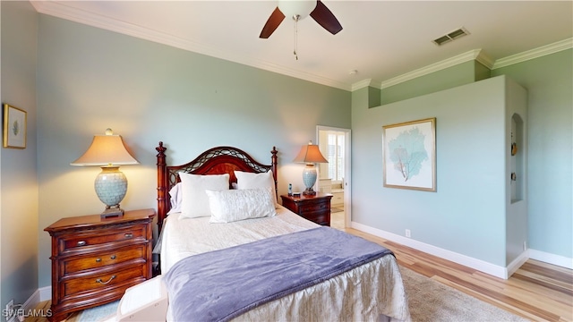 bedroom featuring ornamental molding, ceiling fan, and light hardwood / wood-style flooring