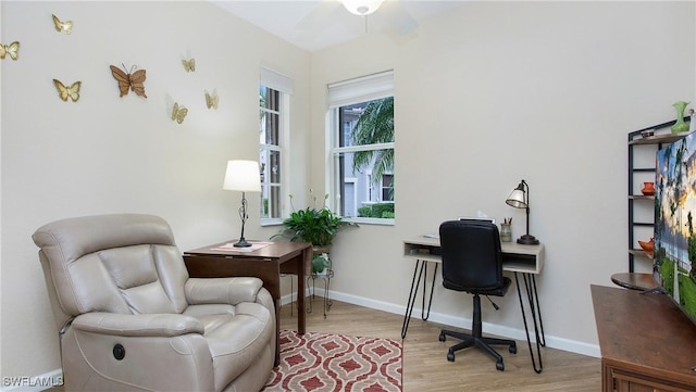 office area with light wood-style floors and baseboards