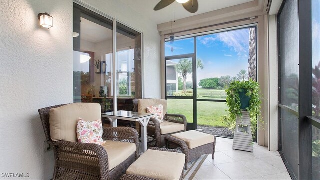 sunroom featuring ceiling fan