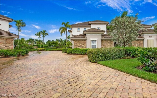 view of front of property with stone siding and stucco siding