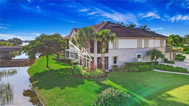 view of side of property with a lawn