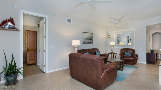 tiled living room with ceiling fan