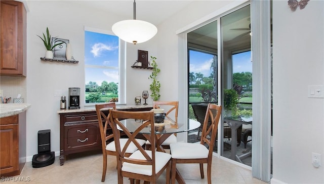 dining room featuring light tile patterned flooring and baseboards