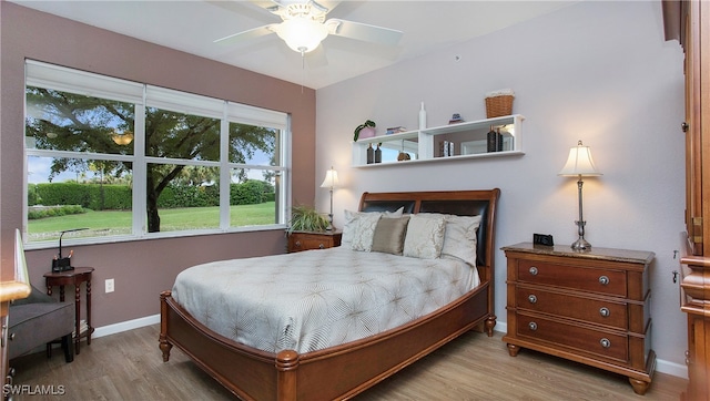 bedroom with ceiling fan and light hardwood / wood-style floors