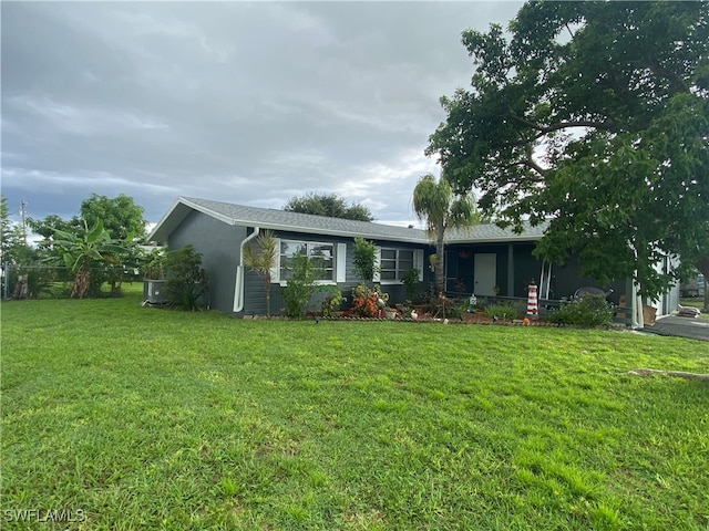 ranch-style home featuring a front yard