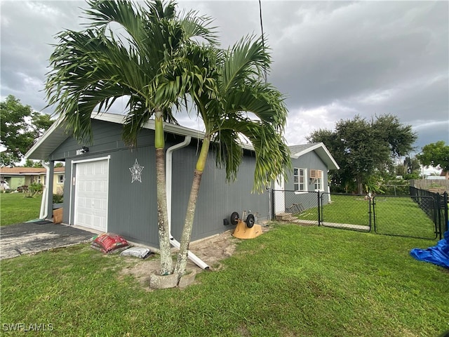 view of side of home with a yard and a garage