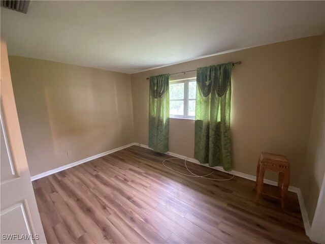 empty room with wood-type flooring