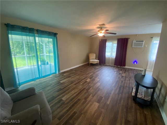 living room with ceiling fan, dark wood-type flooring, and an AC wall unit