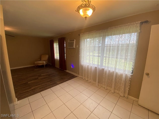 spare room with light hardwood / wood-style floors and a wall mounted AC