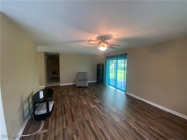 unfurnished living room with ceiling fan and dark hardwood / wood-style flooring