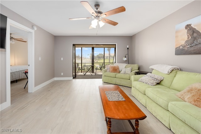 living room featuring light wood-type flooring and ceiling fan