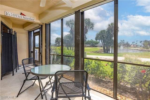 sunroom / solarium with a water view