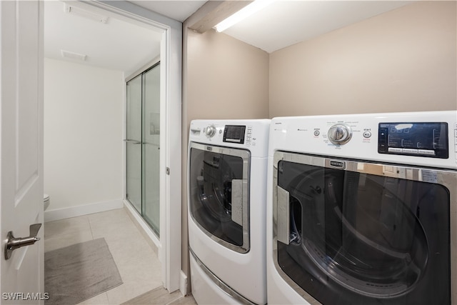 laundry room with light tile patterned flooring and independent washer and dryer