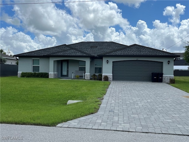 view of front of property with a front yard and a garage