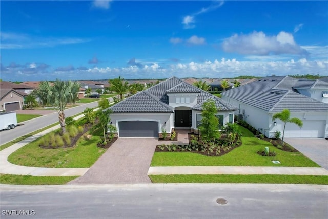 11902 Raggio Dr, Fort Myers, FL 33913 - view of front of home featuring an attached garage, driveway, a residential view, and a front yard