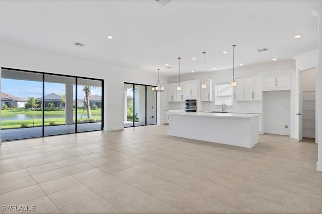 11902 Raggio Dr, Fort Myers, FL 33913 - unfurnished living room featuring recessed lighting, light tile patterned floors, a sink, baseboards, and a water view