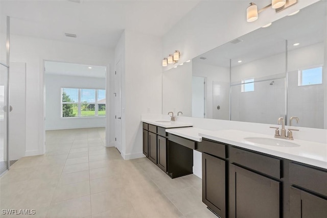 11902 Raggio Dr, Fort Myers, FL 33913 - bathroom featuring double vanity, a tile shower, tile patterned flooring, baseboards, and recessed lighting
