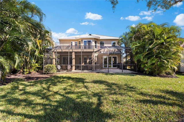 back of house with a lanai, a lawn, a patio area, and a balcony