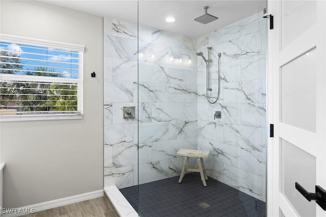 bathroom featuring wood finished floors, recessed lighting, baseboards, and a marble finish shower