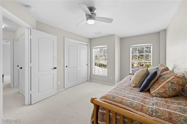 bedroom with ceiling fan and light colored carpet