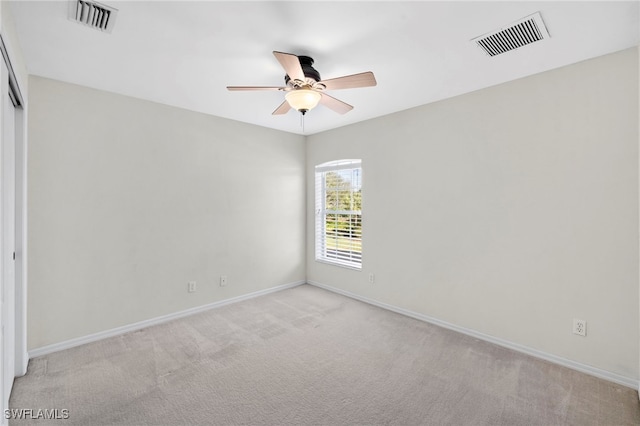 carpeted spare room with ceiling fan