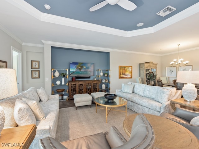 living room featuring wood-type flooring, ceiling fan with notable chandelier, and ornamental molding