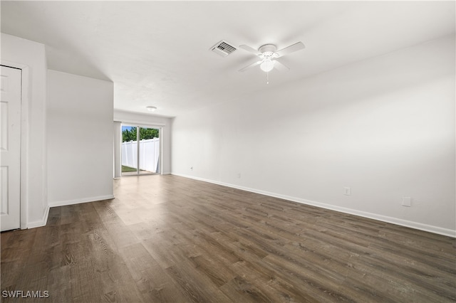 empty room with ceiling fan and dark hardwood / wood-style floors