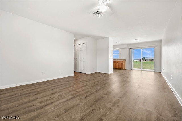 unfurnished living room with ceiling fan and dark hardwood / wood-style floors